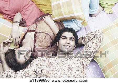 High angle view of a young couple lying down View Large Photo Image Stock Photograph - High angle view of a young couple lying down. Fotosearch