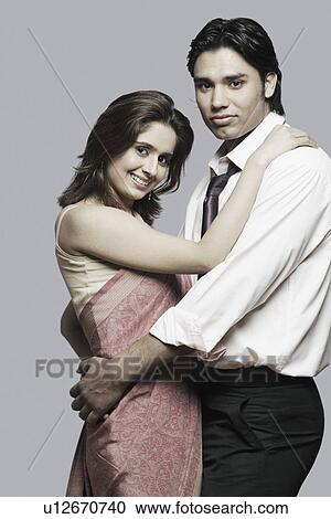 Portrait of a young couple embracing each other View Large Photo Image Stock Image - Portrait of a young couple embracing each other. Fotosearch