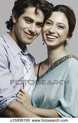 Stock Photo - Portrait of a young couple embracing each other. Fotosearch