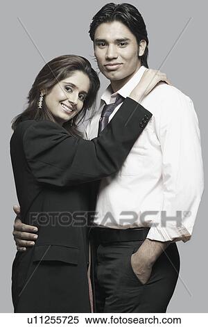 Stock Photography - Portrait of a young couple embracing each other. Fotosearch