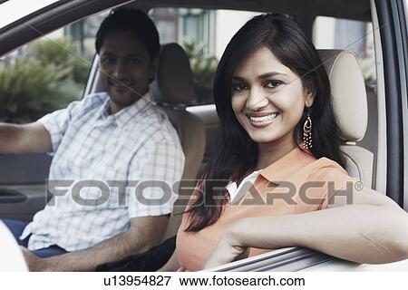 Portrait of a young couple sitting in a car View Large Photo Image Stock Photo - Portrait of a young couple sitting in a car. Fotosearch