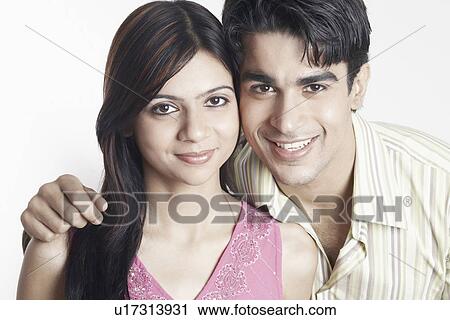 Stock Image - Portrait of a young couple smiling. Fotosearch