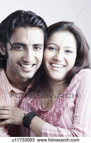 Stock Image - Portrait of a young couple smiling. Fotosearch