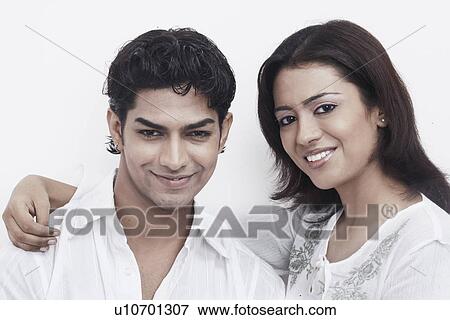 Portrait of a young couple smiling View Large Photo Image Stock Photo - Portrait of a young couple smiling. Fotosearch