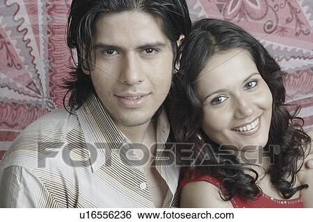Stock Photograph - Portrait of a young couple smiling. Fotosearch