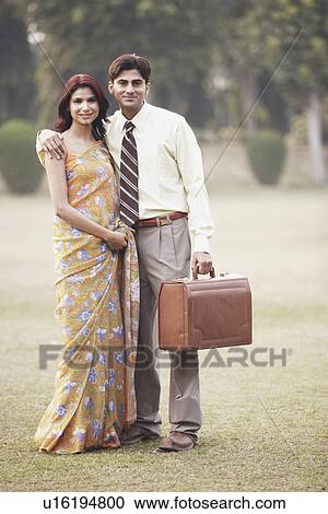 Portrait of a young couple standing in the garden View Large Photo Image Stock Image - Portrait of a young couple standing in the garden. Fotosearch