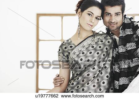 Stock Image - Portrait of a young couple standing. Fotosearch