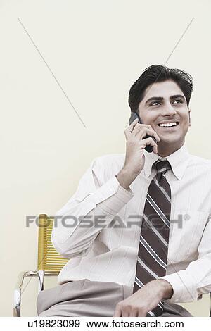 Close-up of a businessman talking on a mobile phone View Large Photo Image Stock Photo - Close-up of a businessman talking on a mobile phone. Fotosearch