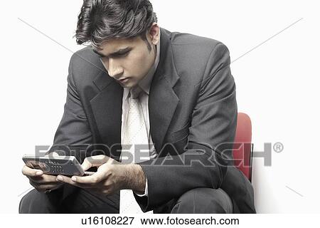 Close-up of a businessman using a mobile phone View Large Photo Image Stock Photo - Close-up of a businessman using a mobile phone. Fotosearch