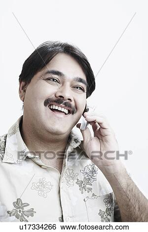 Stock Photograph - Close-up of a mature man talking on a mobile phone. Fotosearch