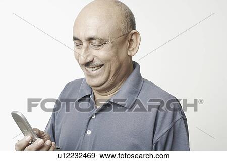 Close-up of a mature man using a mobile phone View Large Photo Image Stock Photo - Close-up of a mature man using a mobile phone. Fotosearch