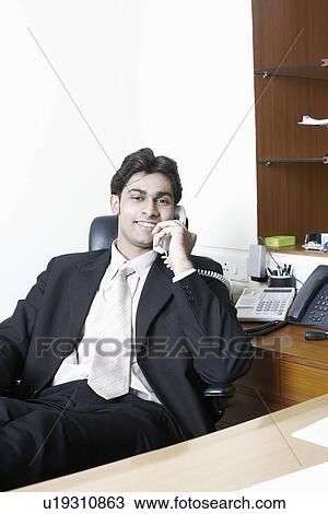 Stock Image - Portrait of a businessman in an office. Fotosearch