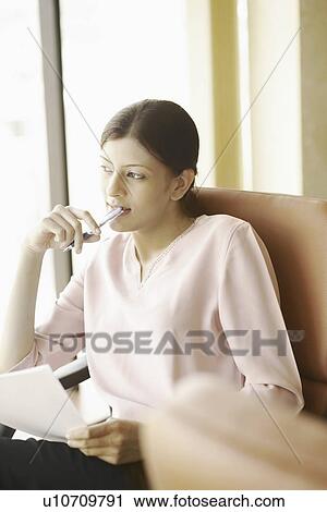 Businesswoman looking out of an office window View Large Photo Image Stock Image - Businesswoman looking out of an office window. Fotosearch