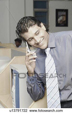 Stock Image - Close-up of a businessman using a mobile phone. Fotosearch