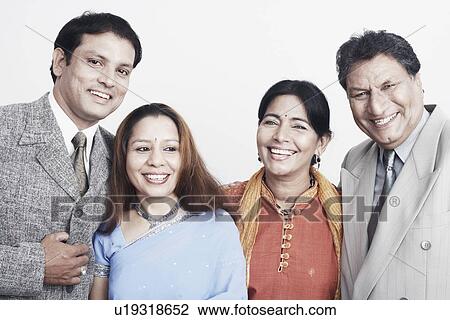 Stock Image - Close-up of two men and two women smiling. Fotosearch