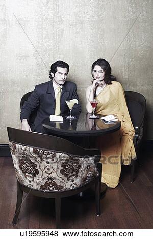 High angle view of a young couple sitting in a restaurant View Large Photo Image Stock Photo - High angle view of a young couple sitting in a restaurant. Fotosearch