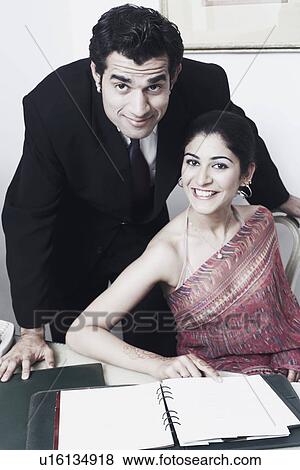 Stock Photo - Portrait of a businessman and a businesswoman smiling. Fotosearch