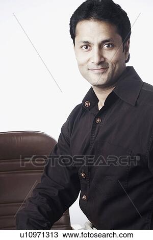 Portrait of a businessman grinning View Large Photo Image Stock Image - Portrait of a businessman grinning. Fotosearch