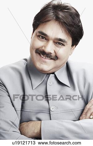 Stock Image - Portrait of a businessman with his arms crossed. Fotosearch