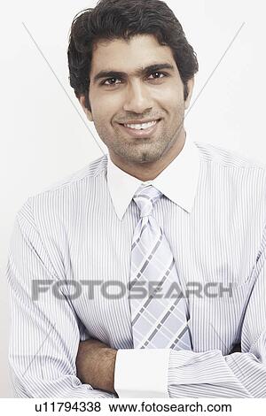 Stock Photo - Portrait of a businessman with his arms crossed. Fotosearch