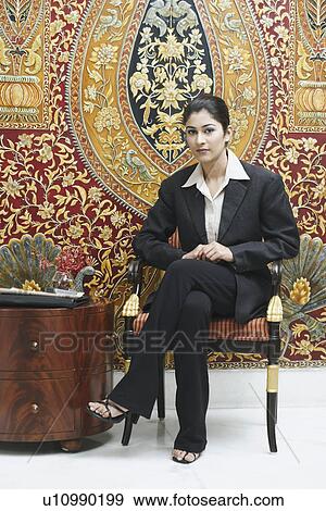 Portrait of a businesswoman sitting in an armchair View Large Photo Image Stock Photo - Portrait of a businesswoman sitting in an armchair. Fotosearch