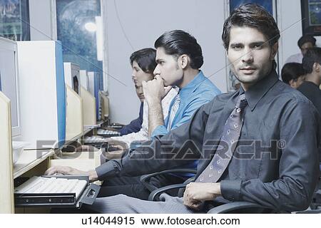 Stock Photography - Portrait of a male office worker in an office. Fotosearch