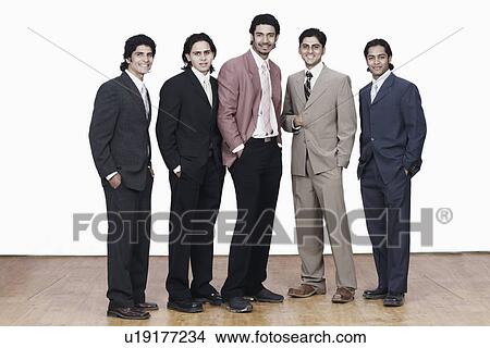 Portrait of five businessmen standing with their hands in their pockets View Large Photo Image Picture - Portrait of five businessmen standing with their hands in their pockets. Fotosearch
