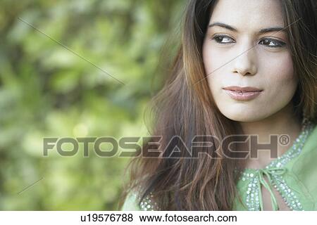 Stock Photo - Close-up of a young woman looking away. Fotosearch