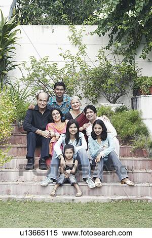 Portrait of a family sitting together on steps View Large Photo Image Stock Photography - Portrait of a family sitting together on steps. Fotosearch