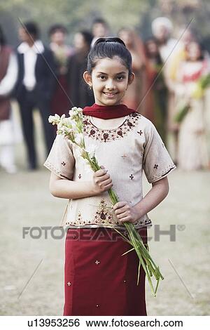 Portrait of a girl holding a bunch of flowers View Large Photo Image Stock Photograph - Portrait of a girl holding a bunch of flowers. Fotosearch