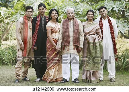 Stock Image - Portrait of a mature couple and their children smiling. Fotosearch