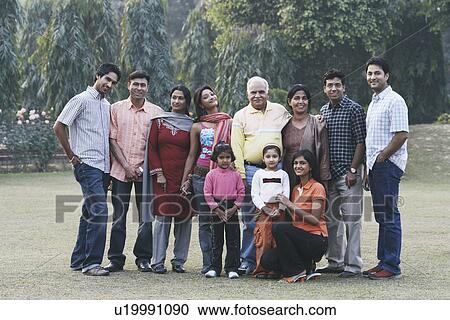 Stock Image - Portrait of a three generation family on a lawn. Fotosearch