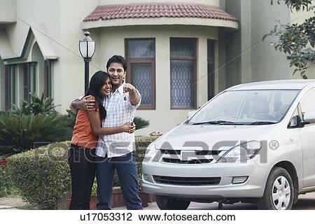 Stock Image - Portrait of a young man standing with a young woman. Fotosearch