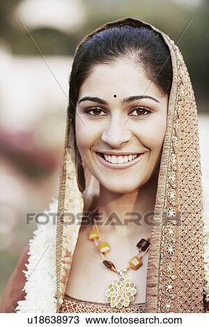 Portrait of a young woman wearing a garland View Large Photo Image Stock Image - Portrait of a young woman wearing a garland. Fotosearch