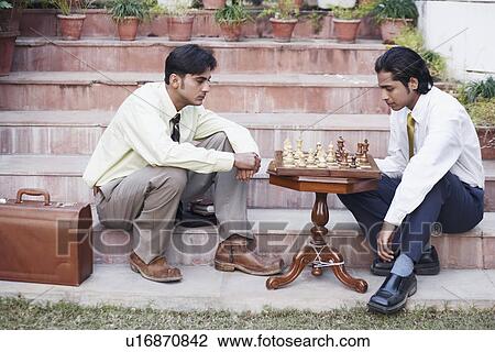 Side profile of two businessmen playing chess View Large Photo Image Stock Image - Side profile of two businessmen playing chess. Fotosearch