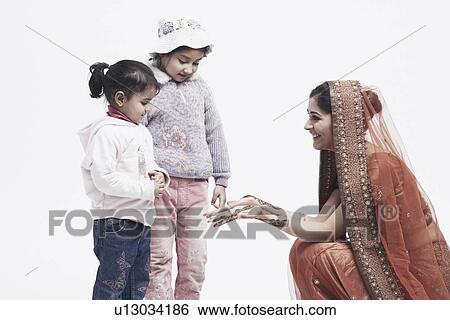 Bride showing her hands to two girls View Large Photo Image Stock Photograph - Bride showing her hands to two girls. Fotosearch