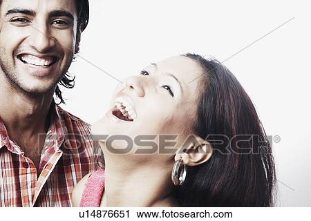 Close-up of a young couple laughing View Large Photo Image Stock Image - Close-up of a young couple laughing. Fotosearch