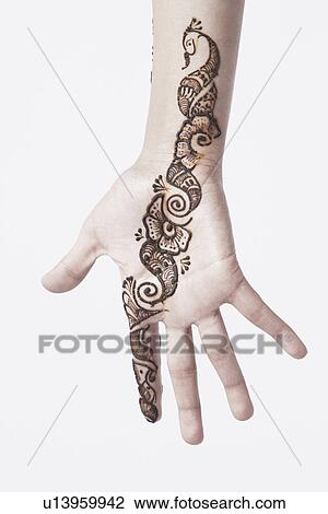Stock Image - Close-up of a young woman with henna tattoo's on her hand. Fotosearch