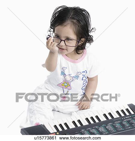 High angle view of a baby girl sitting in front of an electric piano View Large Photo Image Stock Image - High angle view of a baby girl sitting in front of an electric piano. Fotosearch