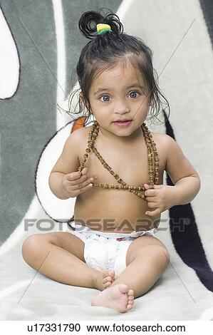 Portrait of a baby girl wearing a necklace View Large Photo Image Stock Image - Portrait of a baby girl wearing a necklace. Fotosearch