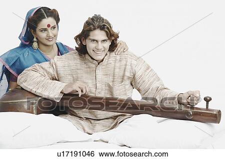 Portrait of a male musician playing the sitar View Large Photo Image Stock Photograph - Portrait of a male musician playing the sitar. Fotosearch
