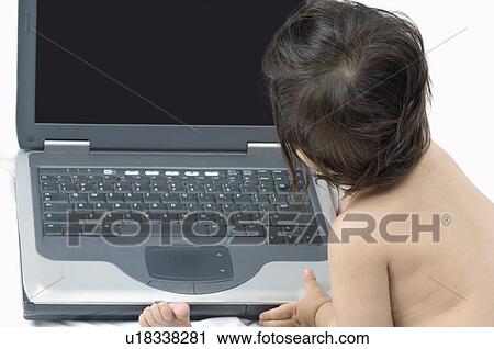 Rear view of a baby boy sitting in front of a laptop View Large Photo Image Stock Image - Rear view of a baby boy sitting in front of a laptop. Fotosearch