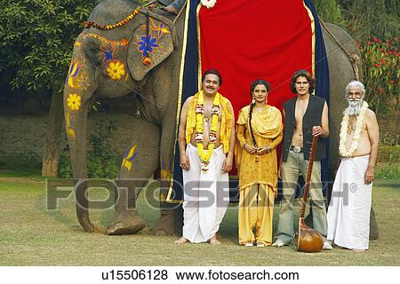 Group of people standing beside an elephant View Large Photo Image Stock Photo - Group of people standing beside an elephant. Fotosearch