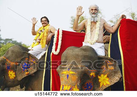 Portrait of two priests riding elephants View Large Photo Image Stock Image - Portrait of two priests riding elephants. Fotosearch