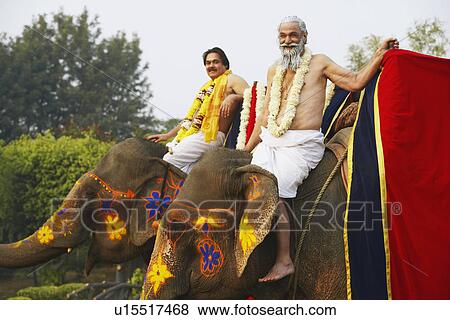 Portrait of two priests riding elephants View Large Photo Image Stock Photo - Portrait of two priests riding elephants. Fotosearch