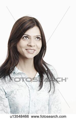 Close-up of a young woman looking up View Large Photo Image Stock Photograph - Close-up of a young woman looking up. Fotosearch