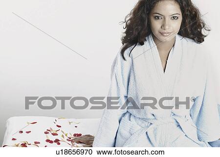 Portrait of a young woman sitting on a massage table View Large Photo Image Stock Image - Portrait of a young woman sitting on a massage table. Fotosearch
