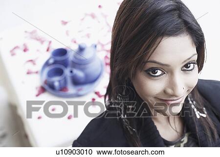 Stock Image - Portrait of a young woman smiling. Fotosearch