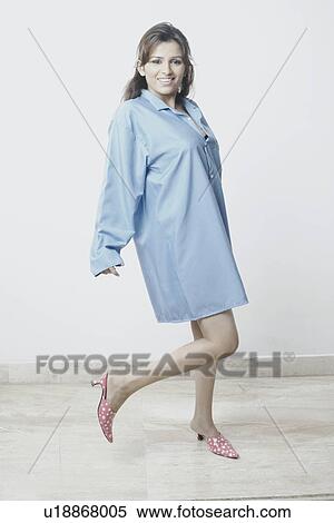 Stock Photography - Portrait of a young woman wearing a nightdress. Fotosearch