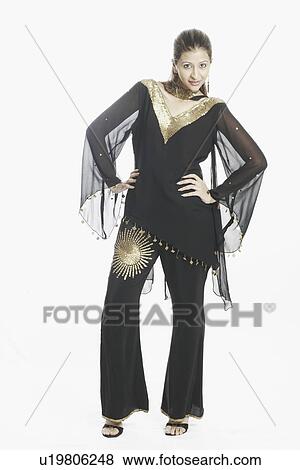 Portrait of a young woman with arms akimbo View Large Photo Image Stock Photo - Portrait of a young woman with arms akimbo. Fotosearch